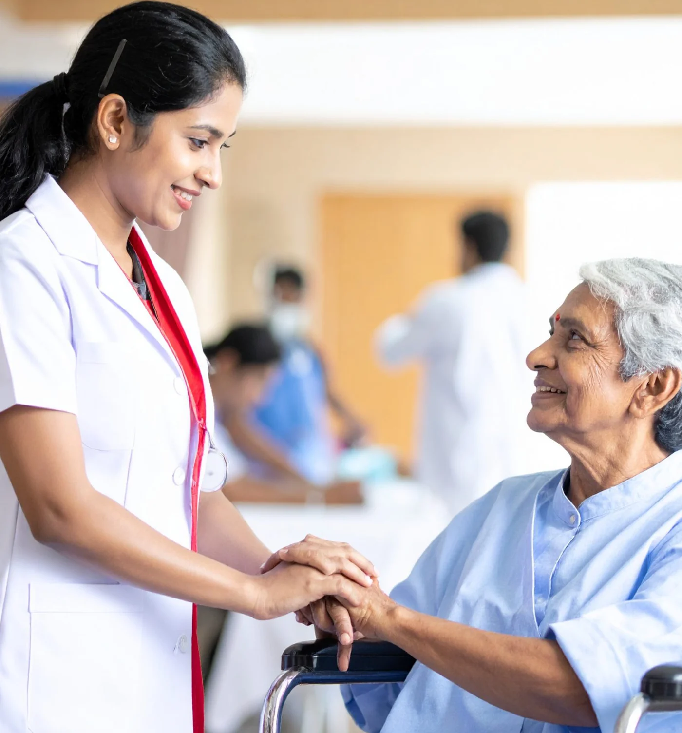 Nurse supporting an elderly woman